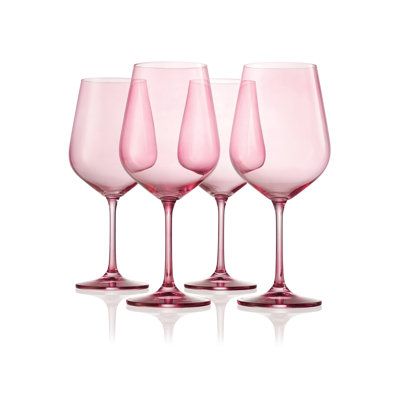 four pink wine glasses sitting next to each other