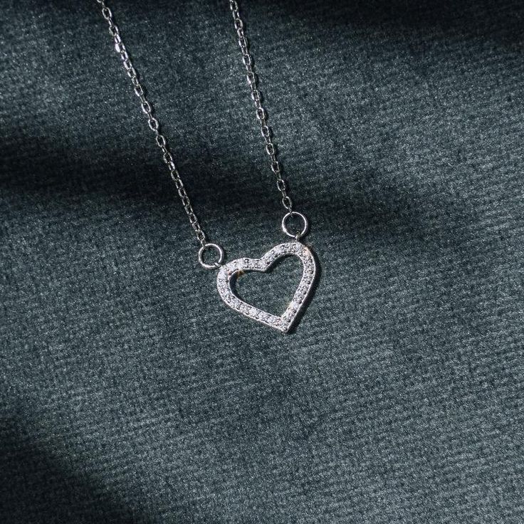 Crafted of .925 polished sterling silver, our Mini Diamond Heart Pendant offers a lovely look and is sure to go with your everyday style. It is suspended from a small rope chain that will definitely give you a sophisticated look. Klasē brings you the highest standard of jewelry. We fully warrant the authenticity of our materials and are pleased to offer our jewelry patrons a lifetime guarantee. Specifications Adjustable chain up to 18" Material Options Sterling Silver 14k yellow gold Tiny Sterling Silver Heart Pendant, Heart-shaped Sterling Silver Necklace With Single Cut Diamonds, Tiny Heart-shaped Silver Necklace, Tiny Heart-shaped Sterling Silver Charm Necklaces, Nickel-free Sterling Silver Heart Pendant Charm, Heart Pendant Diamond, Mini Heart, Rope Chain, Diamond Heart