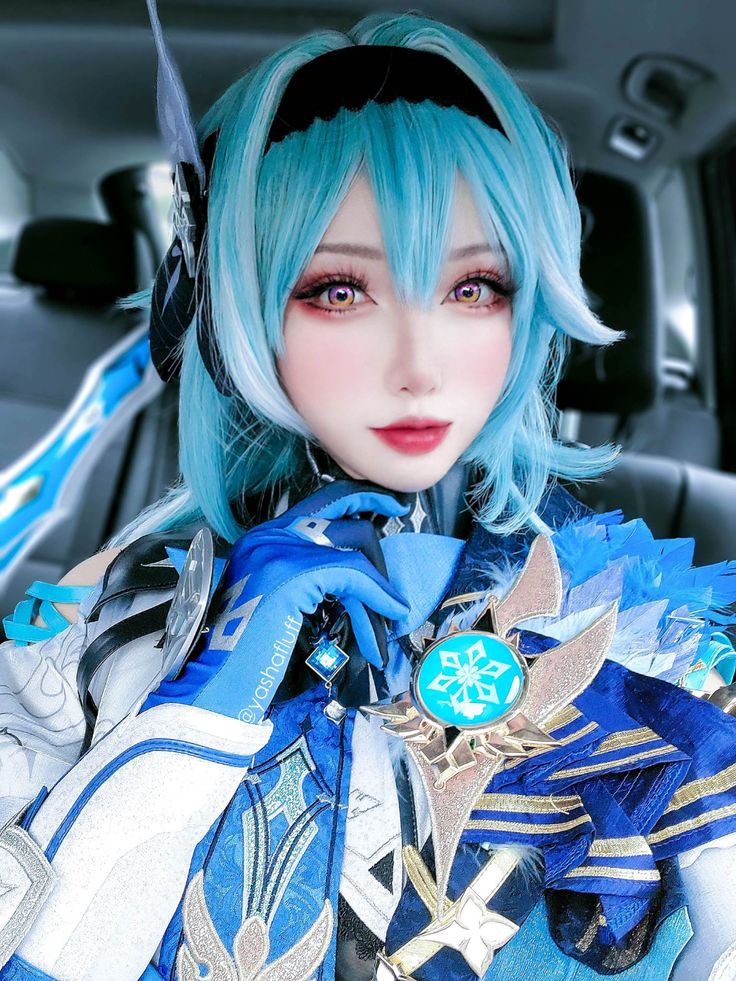 a woman with blue hair and headphones in a car