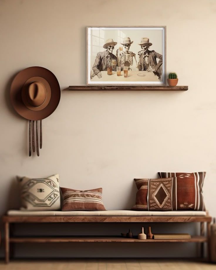 a room with a bench, hat rack and two pictures on the wall above it