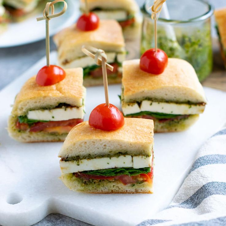 small sandwiches with tomatoes and mozzarella on them