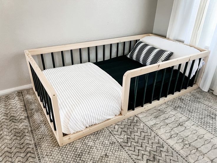 Black Montessori Floor Bed We want to make your toddlers transition from crib to bed easy and fun with our Sori Floor Beds! Our simple design keeps the safety of your child in mind and helps them feel safe and secure in a semi closed environment. Our beds will allow your child comfort and give them freedom of movement that can foster independence in their own space to help develop confidence. Our beds are not only great for your kiddos, but fantastic for those pre-bedtime snuggles with the famil Floor Beds, Montessori Floor Bed, Toddler Boys Room, Bed Dimensions, Floor Bed, Toddler Bedrooms, Big Boy Room, Feel Safe, Baby Boy Rooms