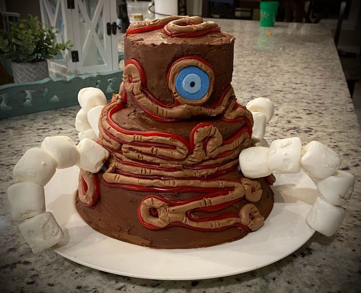 a large chocolate cake with an evil eye on it's face and eyes in the middle