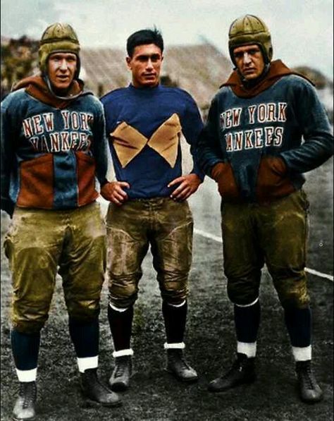 three men in football uniforms standing next to each other