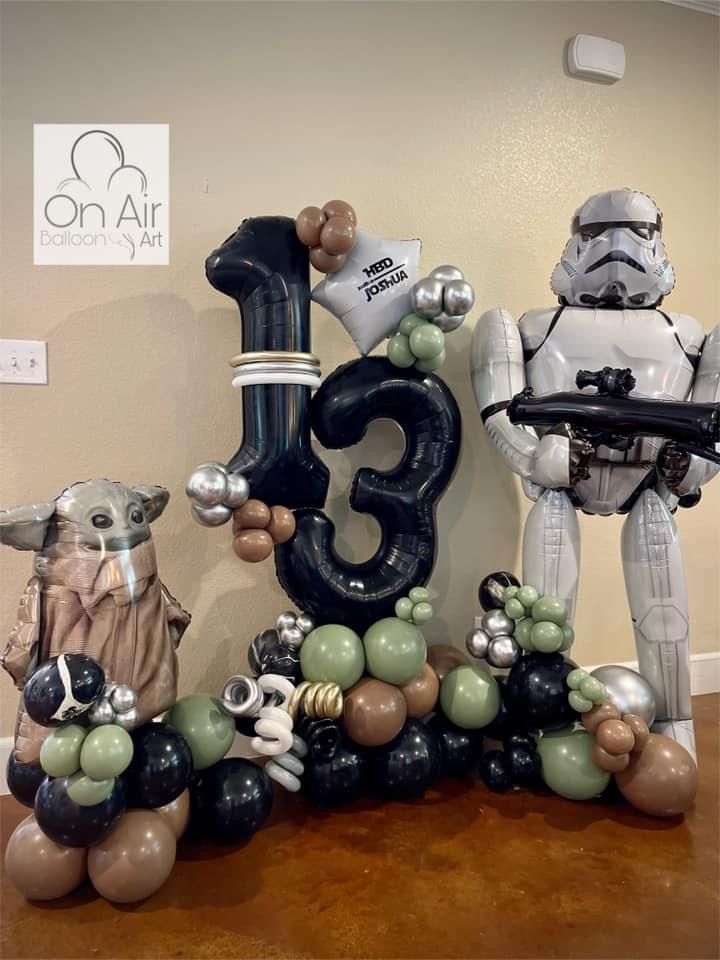 star wars balloon decorations are on display in the office space, including an inflatable number