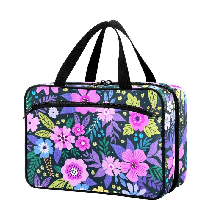 a colorful floral print bag with black handles