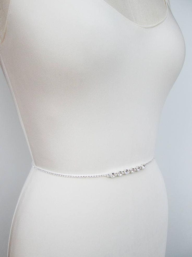 "This sparkly super skinny bridal belt is made with Swarovski crystals beaded on a 1/8\" wide ribbon. The crystal part of the belt measures 26\" long with the center detail measuring 3\" long. Finished with the 1/4\" satin ribbon ties in the back. The entire sash measures 150\" long. Available in gold, silver or rose gold finish. - For the photo of the ribbon color options please take a look here: https://www.etsy.com/listing/225025505/satin-ribbon-swatches-ribbon-color?ref=shop_home_active_92 - Fitted Rhinestone Belts For Party, Silver Fitted Bridal Belt For Formal Occasions, Elegant Crystal Bridal Belt, Elegant Bridal Belt For Bridesmaid, Elegant Fitted Bridal Belt, Fitted Silver Crystal Bridal Belt, Fitted Silver Bridal Belt With Sashes, Fitted Crystal Bridal Belt For Party, Silver Fitted Bridal Belt For Bridesmaid