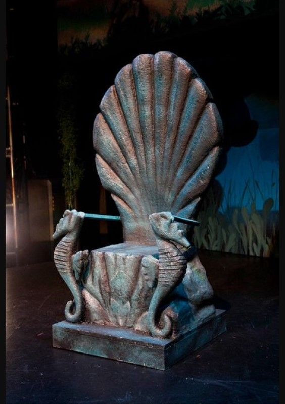 an image of a statue that looks like a shell with a dolphin on it's back