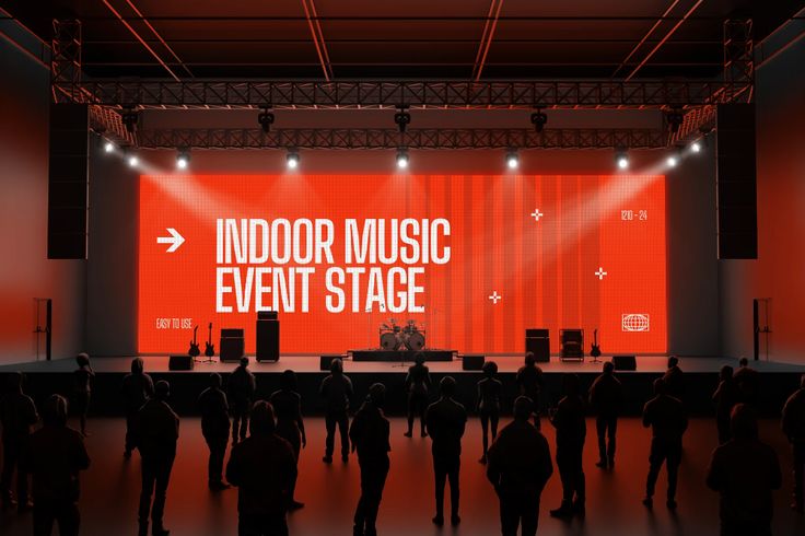 an indoor music event stage is lit up with red lighting and people standing in front of it