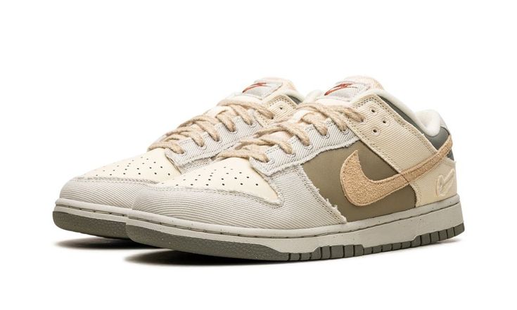 The Women’s Nike Dunk Low “Light Bone/Dark Stucco” is a women’s-exclusive colorway of the retro basketball shoe with a unique combination of materials.  The Dunk Low “Light Bone/Dark Stucco” is made from materials such as leather, canvas, suede, and hemp.  A Sesame-colored suede Swoosh appears on the sides, while Light Bone frayed canvas overlays can be seen on the toe, forefoot, eyelets, collar, and heel.  Dark Stucco leather is located on the heel.  A Swoosh logo is debossed on the lateral side of the heel, while classic “Nike” branding appears in red lettering on the canvas tongue tag.  A Light Bone midsole and Dark Stucco outsole complete the look.  Release date: March 5, 2024 Nike Dunk Low Light Bone, Dunk Low Light Bone, Dark Stucco, Olive Shoes, Retro Basketball Shoes, Nike Branding, Pretty Shoes Sneakers, Retro Basketball, Kawaii Shoes