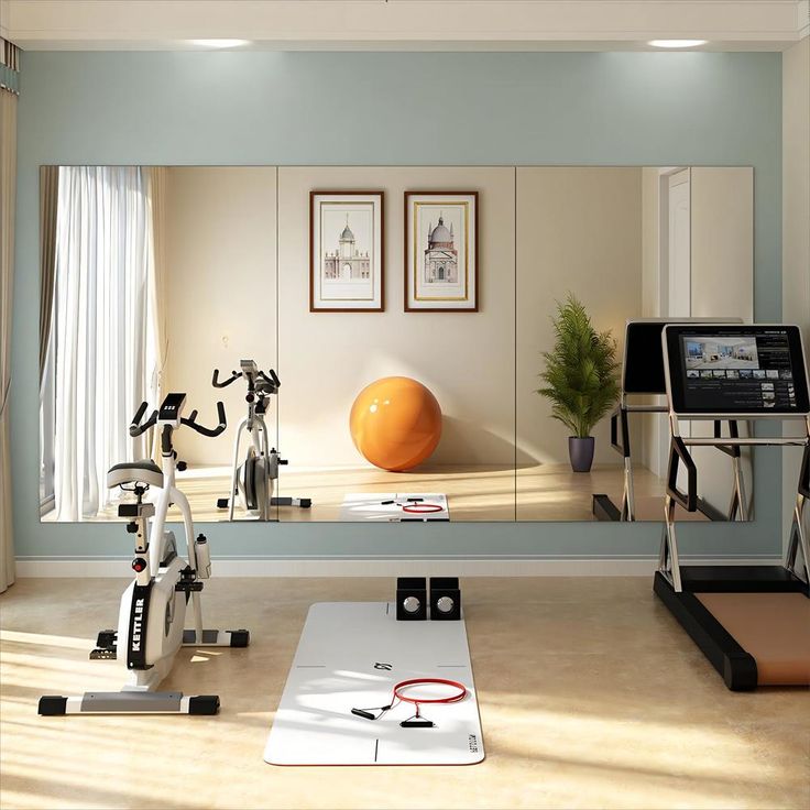 a room with exercise equipment and mirrors in it