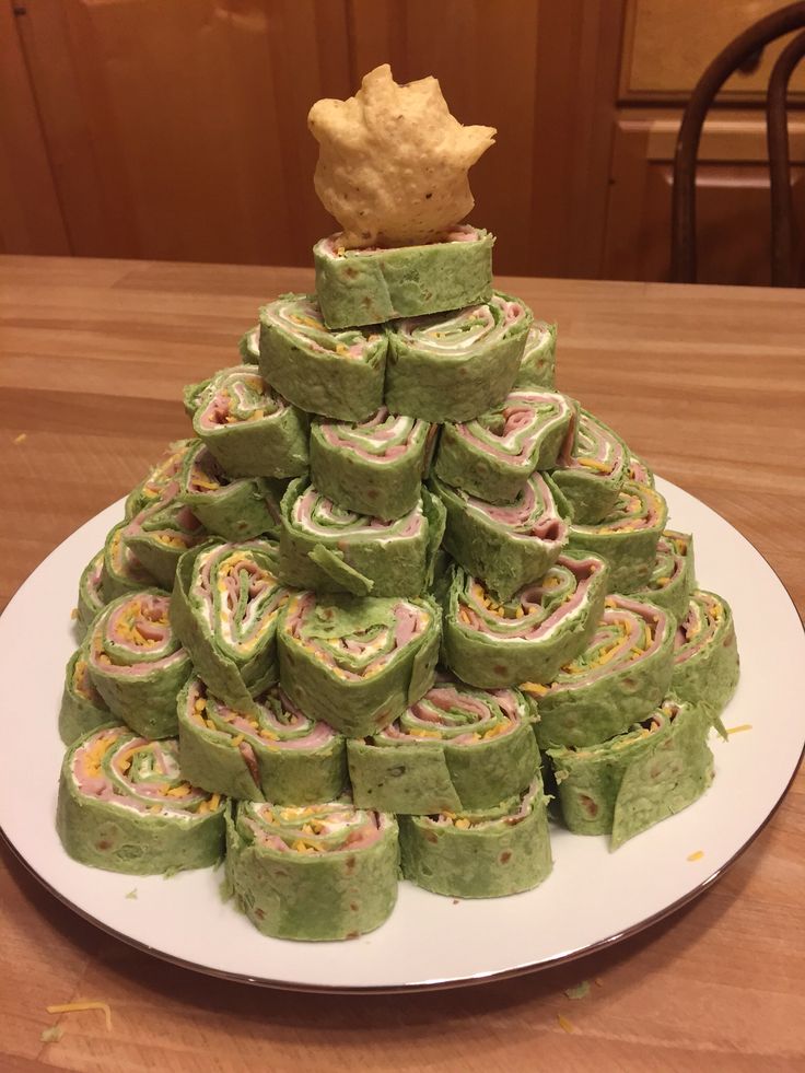 a plate that has some kind of food on it and is stacked up in the shape of a christmas tree