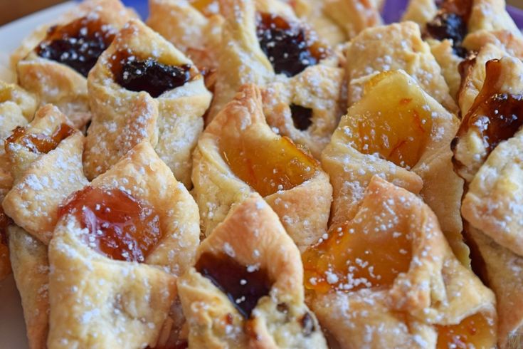 a white plate topped with pastries covered in jelly