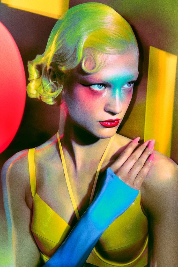 a woman with bright makeup and neon make - up