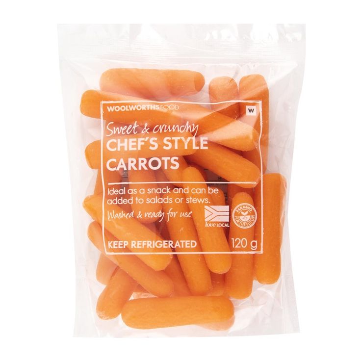 a bag of carrots sitting on top of a white table