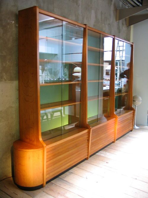 a wooden shelf with glass doors on it