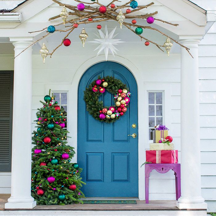 a blue front door decorated with christmas decorations