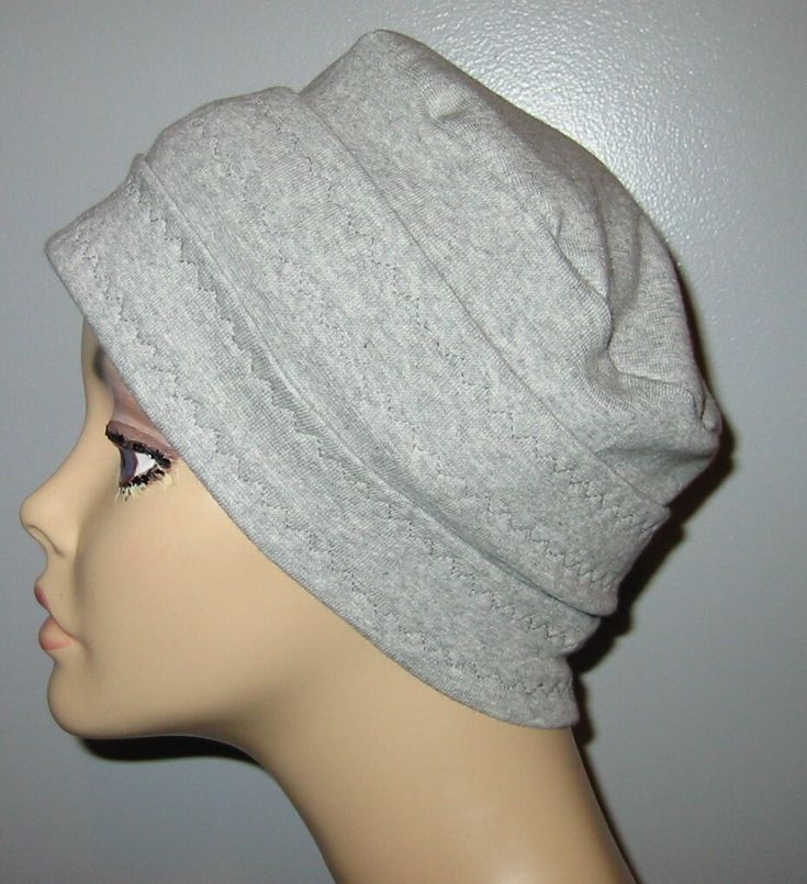 a mannequin head wearing a gray hat