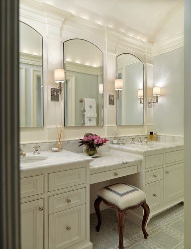 a large bathroom with double sinks and mirrors