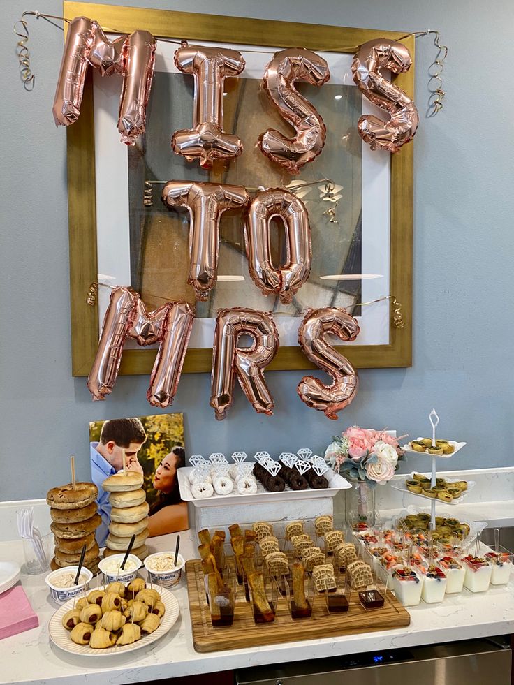 a table filled with desserts and balloons that say it's not girls on it