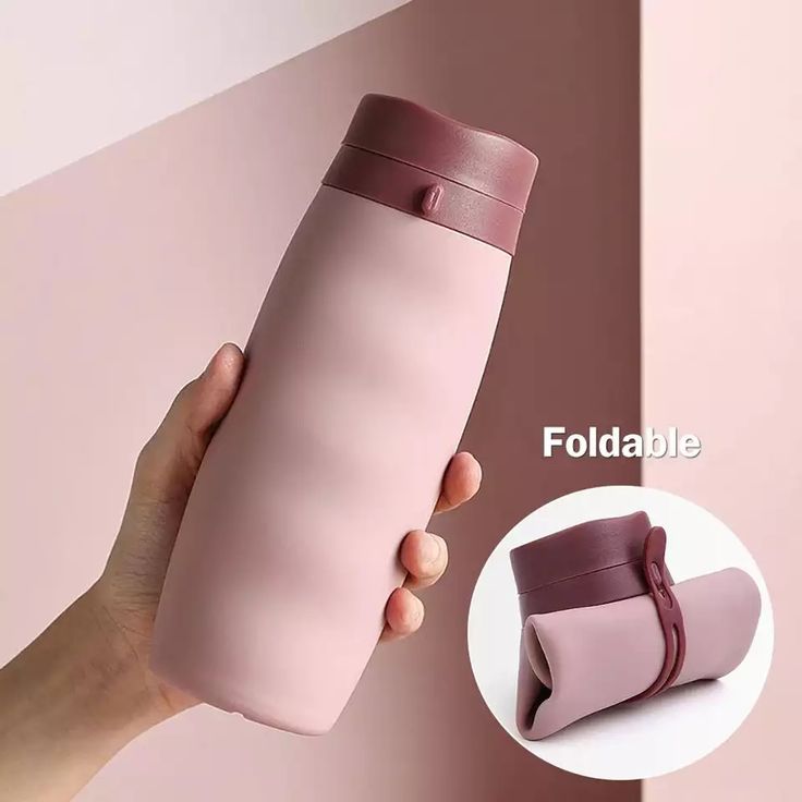 a hand holding a pink tumbler cup next to a pink wall with the words foldable on it