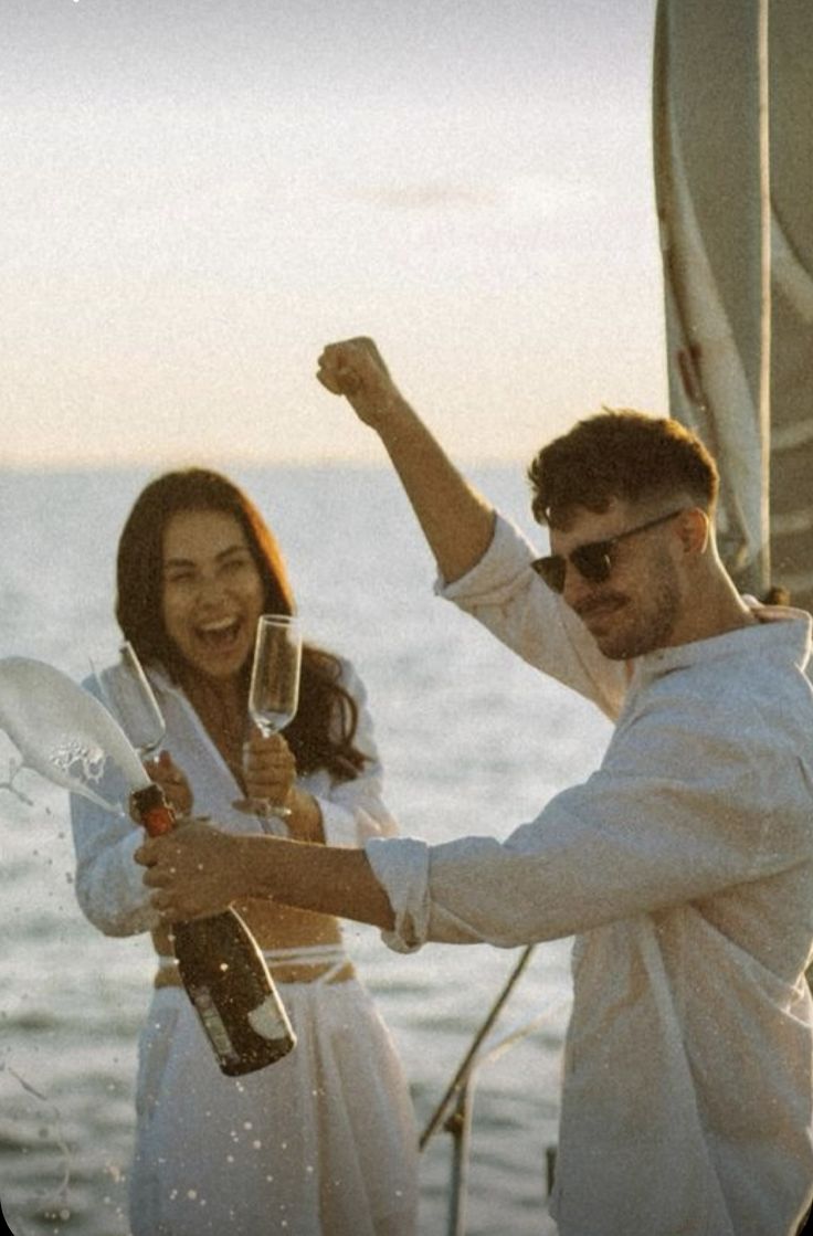 two people on a boat holding wine glasses