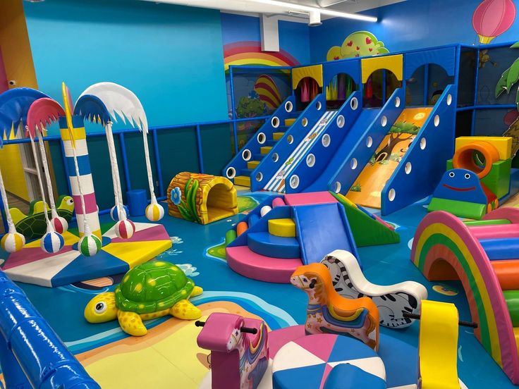 an indoor play area with slides and toys