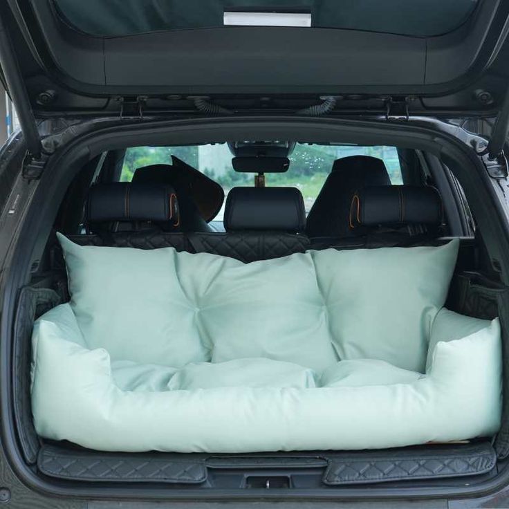 the back end of a car with pillows in it