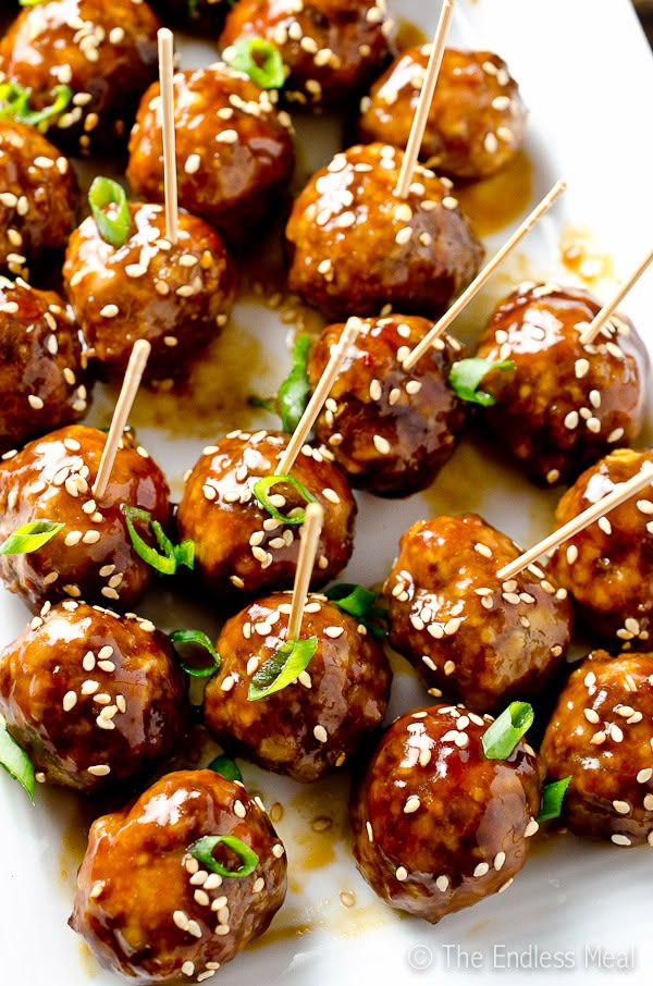 meatballs with sesame seeds and garnish on skewers ready to be eaten