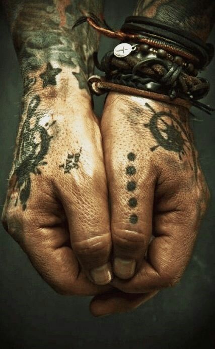 a person with tattoos on their hands and wrist