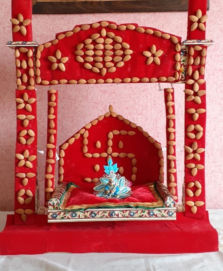 an elaborately decorated red bed in a pink room