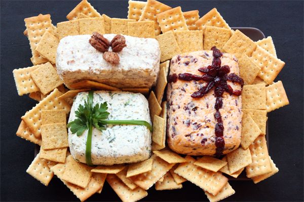 three sandwiches and crackers are sitting on a platter