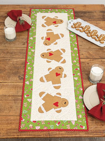 the table runner has gingerbreads on it