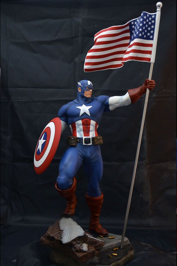 a statue of captain america holding an american flag