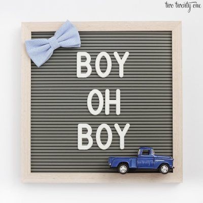 a blue toy truck with a bow on its head and the words boy oh boy written in white