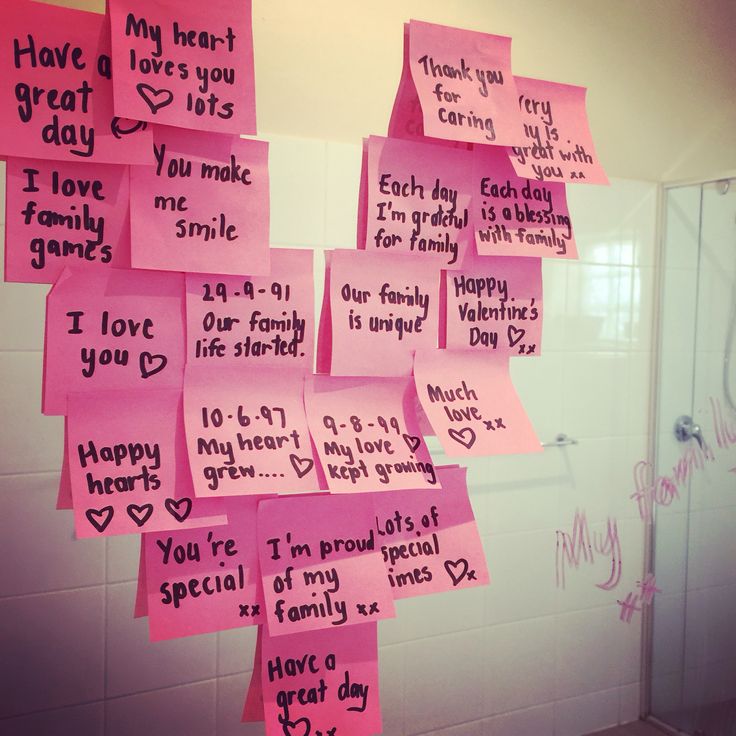 pink post it notes hanging on the wall in a bathroom with words written on them