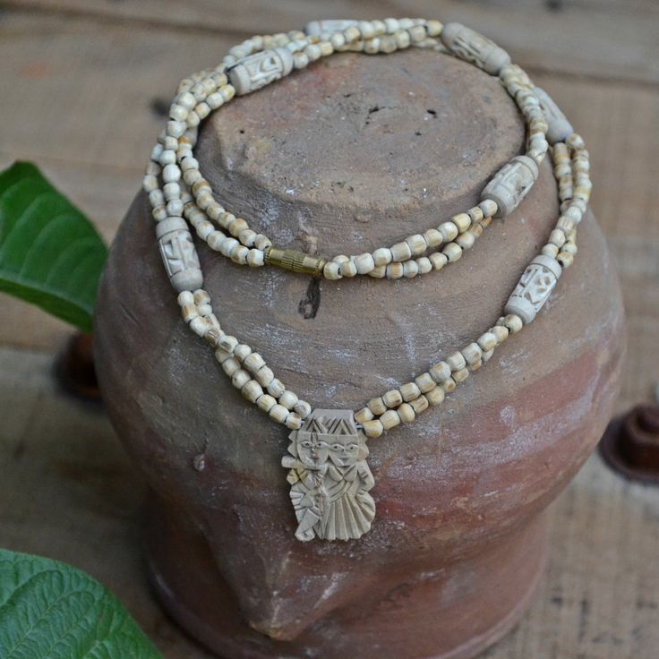 📿The necklace entirely made of natural white Tulsi beads makes a charming and divine possession for Krishna devotees. It features Radha carved cylindrical shape beads with round beads on sides assembled in a repeated pattern. The centre pendant with a fine and neat carving of Radha and Krishna playing the flute adds to the charm and divinity of the necklace. Tulsi is associated with Lord Krishna and a mala made of Tulsi wood is considered to be highly purifying. It purifies the mind and body an Krishna Necklace, Tulsi Mala, Radha And Krishna, Playing The Flute, Seed Necklace, Repeated Pattern, Basil Seeds, Rudraksha Mala, Holy Basil