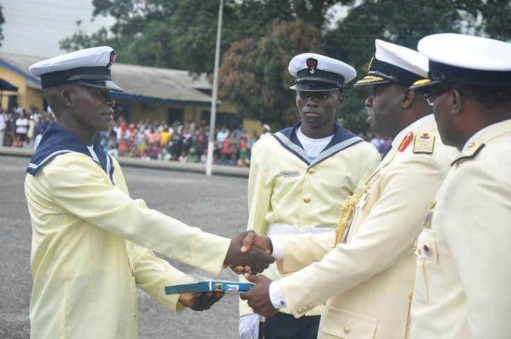 two navy officers shaking hands with each other