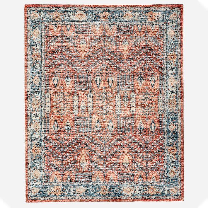 an orange, blue and red rug on a white background with lots of small details