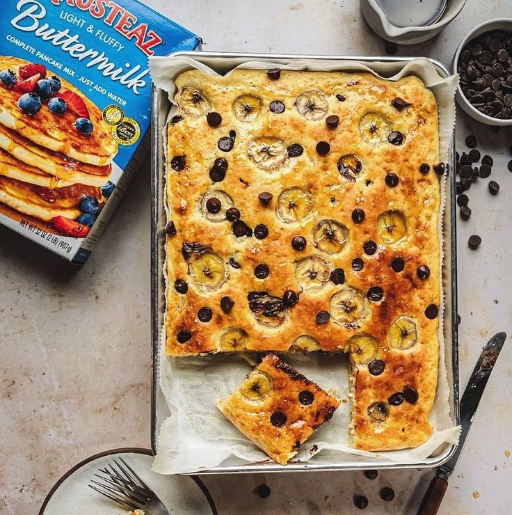 a pan filled with blueberries and bananas next to a box of buttermilk