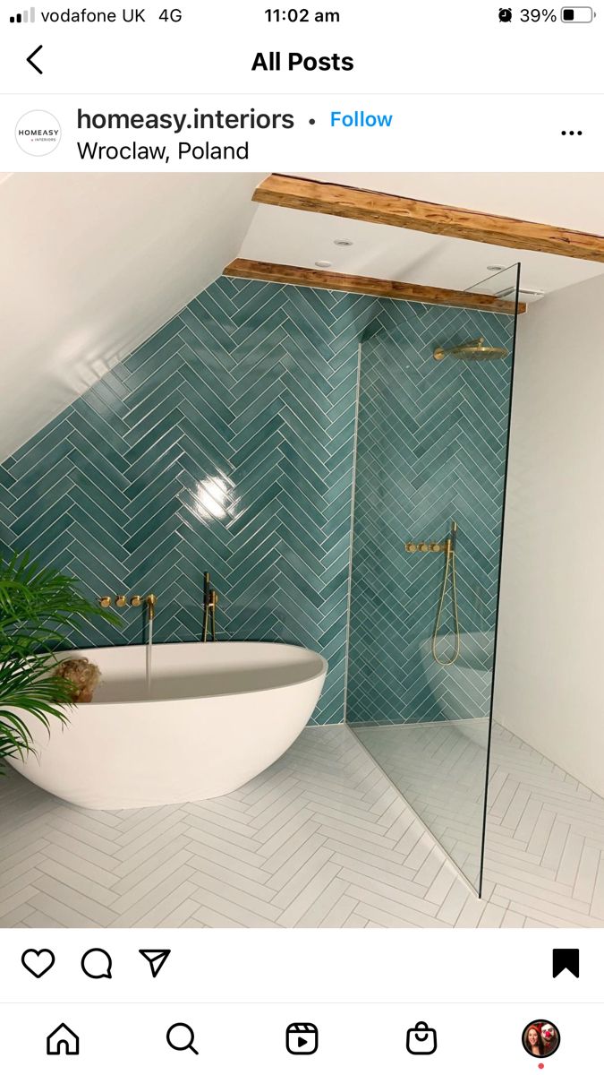 the bathroom is decorated in blue and white tile, with a free standing tub next to it