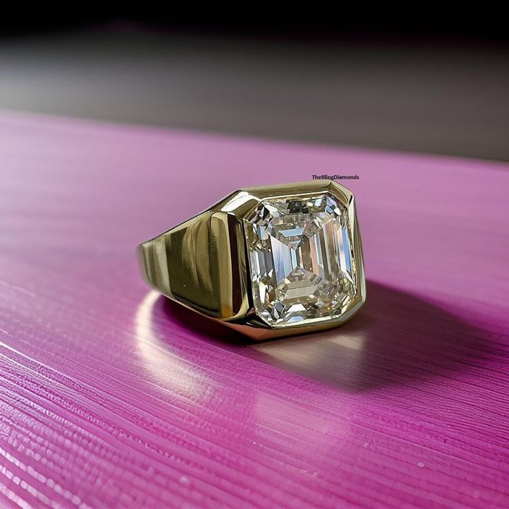 an old - fashioned diamond ring sits on a purple surface, resting on a table