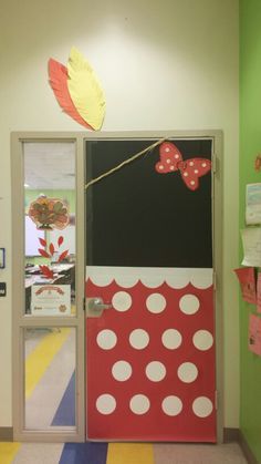 the door is decorated with red and white polka dots, a bow on a string