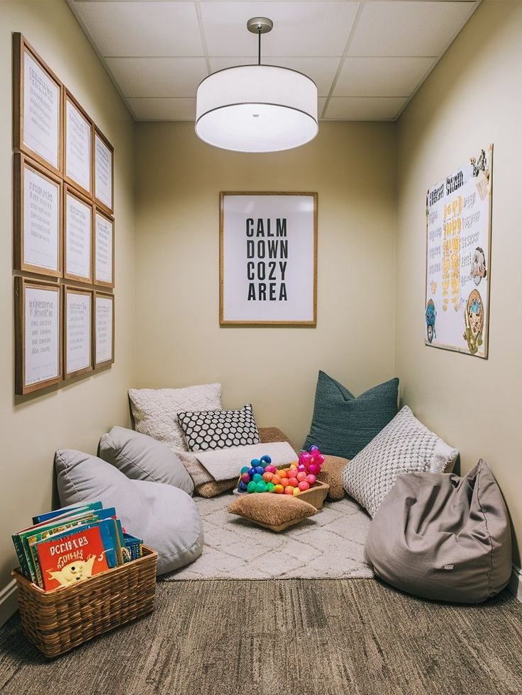 a room filled with lots of pillows and stuffed animals on the floor in front of posters