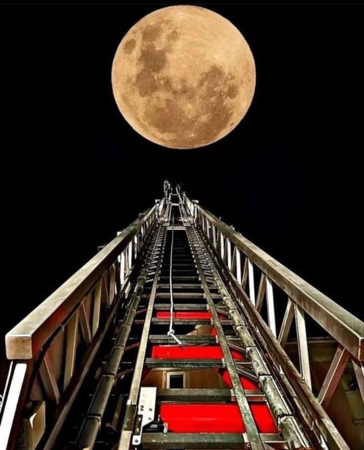 a firetruck with the moon in the background and red carpet on the floor