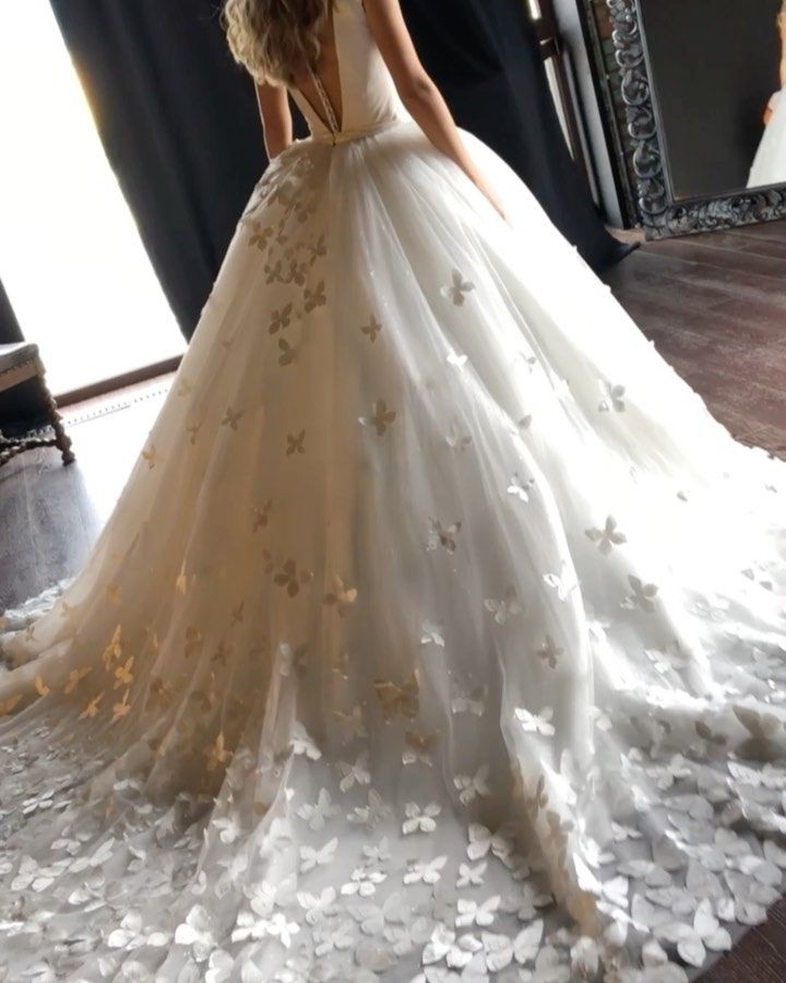 a woman in a wedding dress is standing on the floor with petals all over her