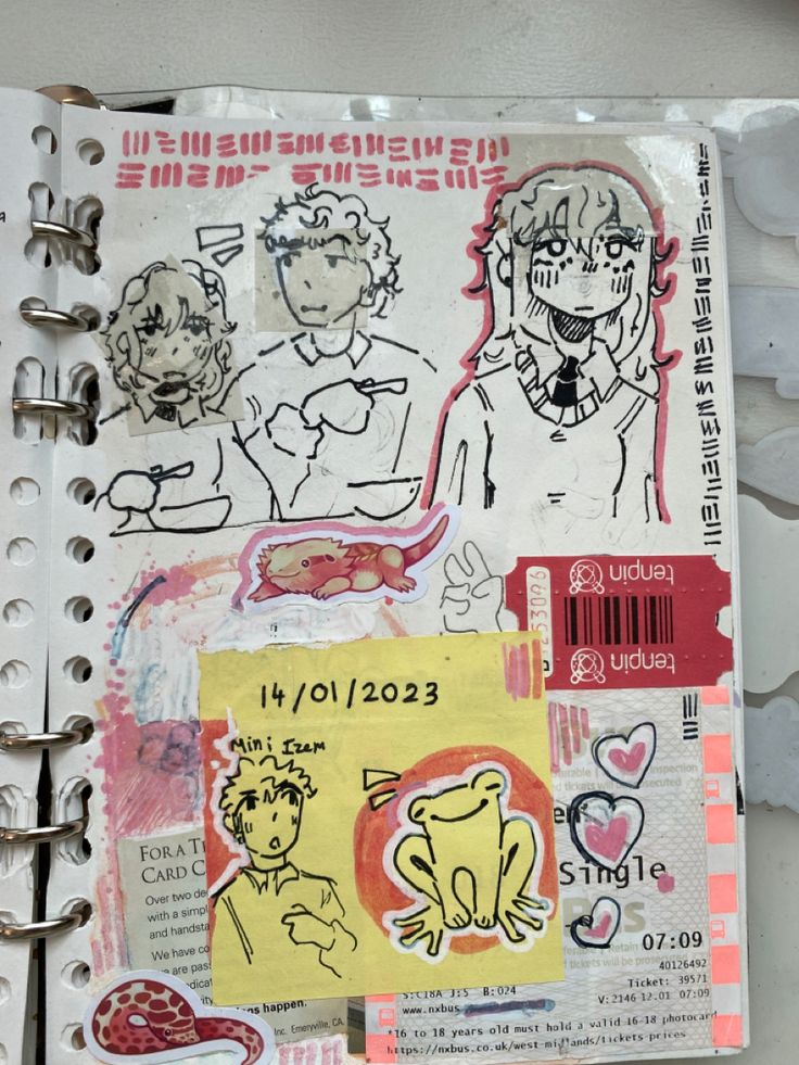 an open notebook with some drawings on it