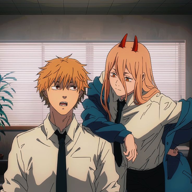 two people with horns on their heads are standing in an office setting, one is holding the other's shoulder