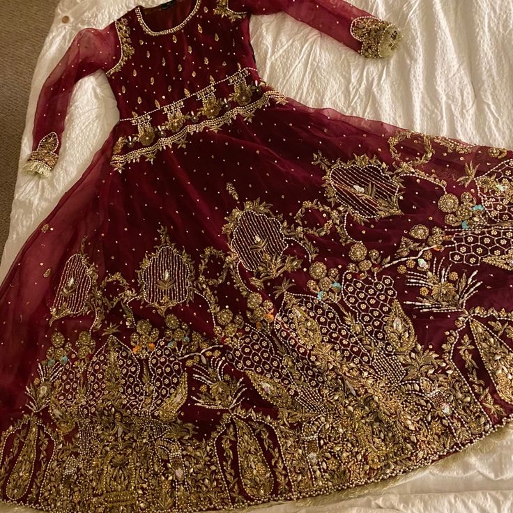 Brand New, Tried On But Not Worn. Lots Of Space In The Inside To Let Out. Full Length Gown. Comes With Trousers And Plain Dupatta With Scattered Kaam. Handwork Authentic Gown In Deep Red With Fringe On Order And Lined With Damask. Regal And Beautiful. All Work Done With Sequins, Pearls, And Beading. Really Heavy. Back Has Work Too As Shown. #Pakistani #Handmade #Zardozi #Indian #Bengali #Bangladeshi #Bridal #Shaadi Hand Embellished Maxi Wedding Gown, Festive Anarkali Wedding Dress For Party, Hand Embellished Maxi Wedding Dress, Elegant Wedding Evening Dress With Zari Work, Gold Floor-length Wedding Dress With Dabka Work, Organza Wedding Evening Dress With Intricate Embroidery, Red Organza Floor-length Gown, Red Floor-length Organza Gown, Anarkali Floor-length Wedding Evening Dress