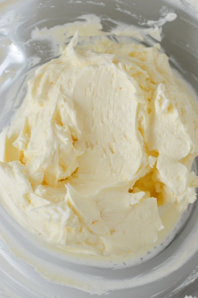 a bowl filled with cream sitting on top of a table